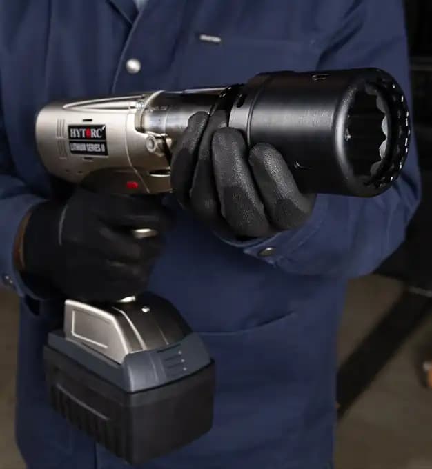 A technician holding a HYTORC Lithium Series II electric torque tool