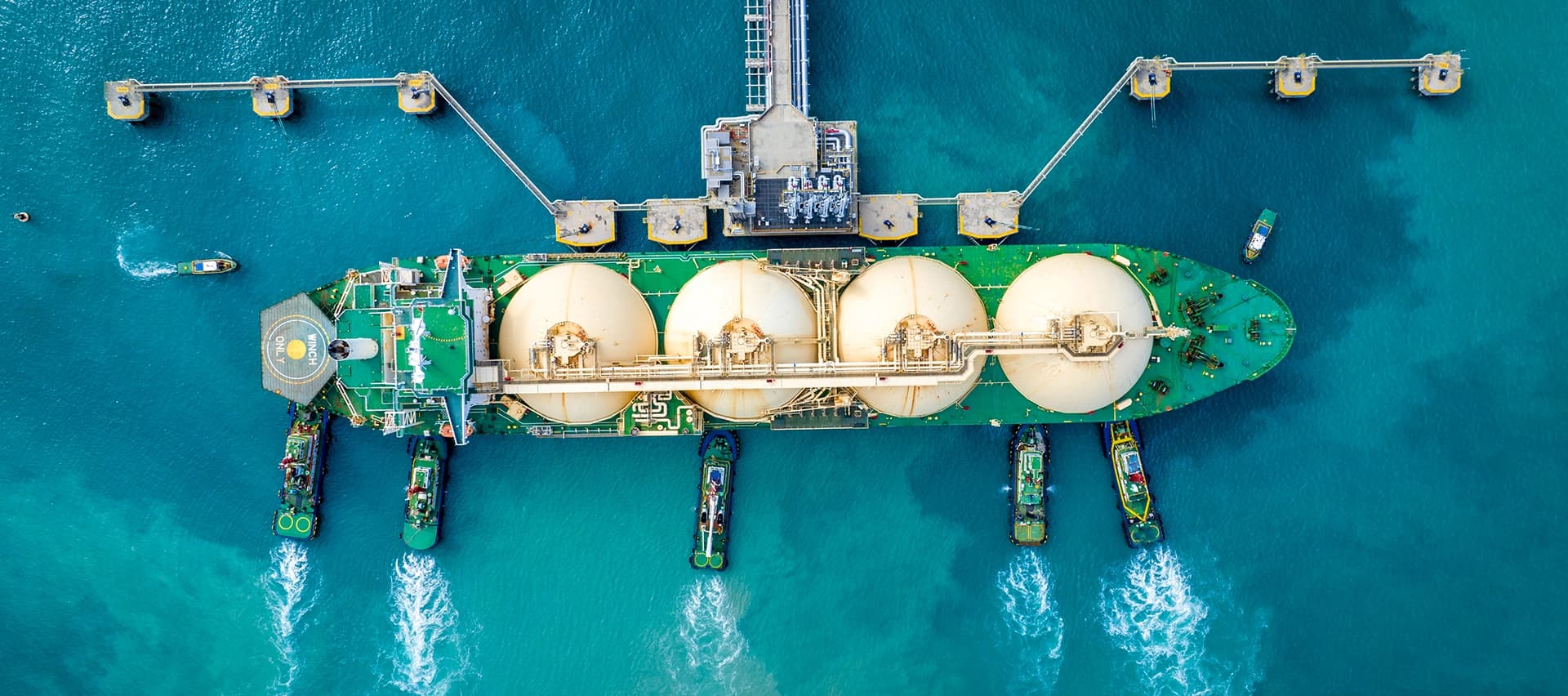An aerial view of storage tanks for liquefied natural gas, showing the scale of these operations.