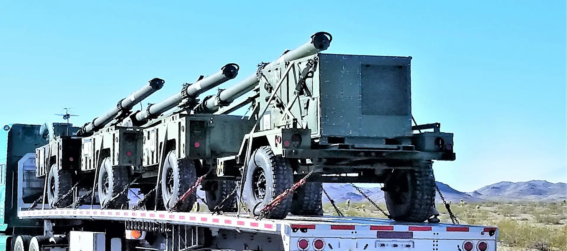 A set of cannons on a military fleet truck, showing the importance of proper bolting in the military.