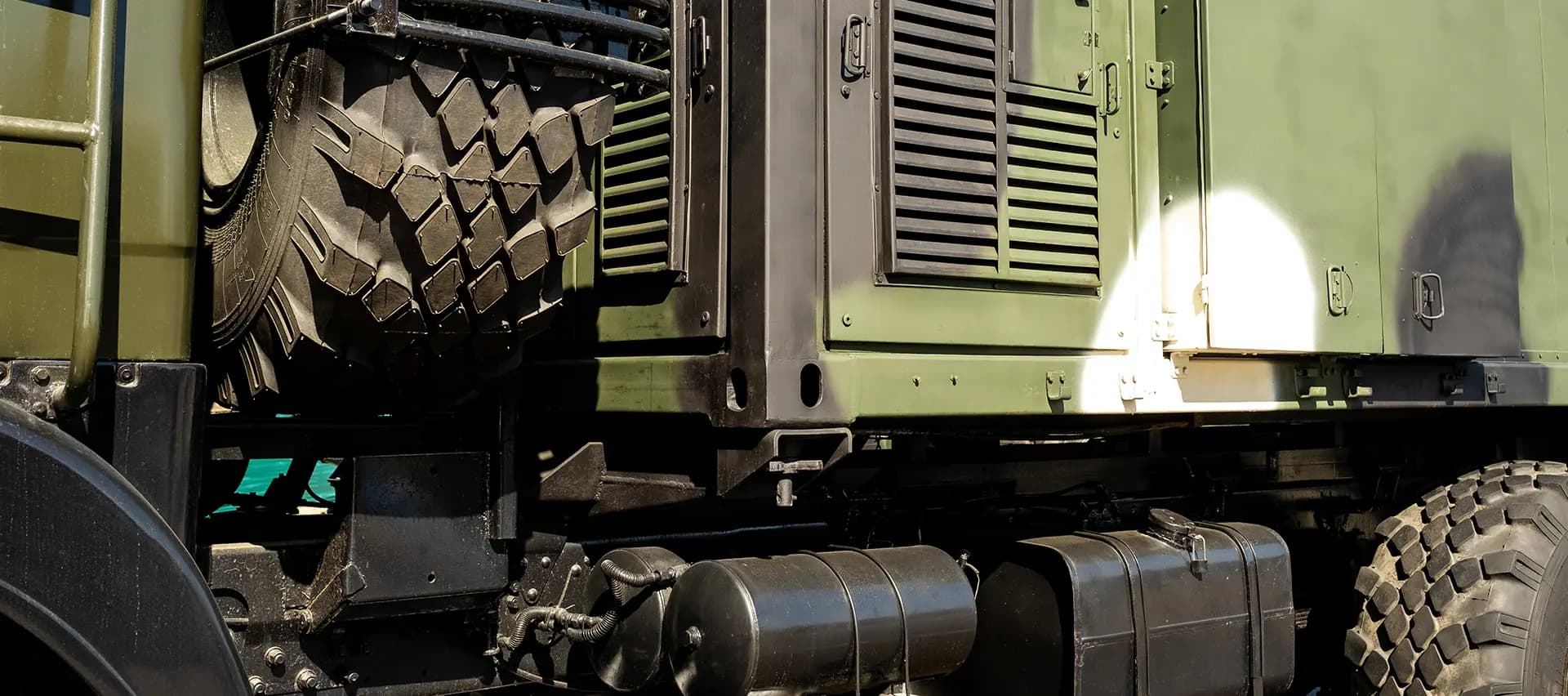 A side view of a military truck, showing the importance of proper bolting in the military.