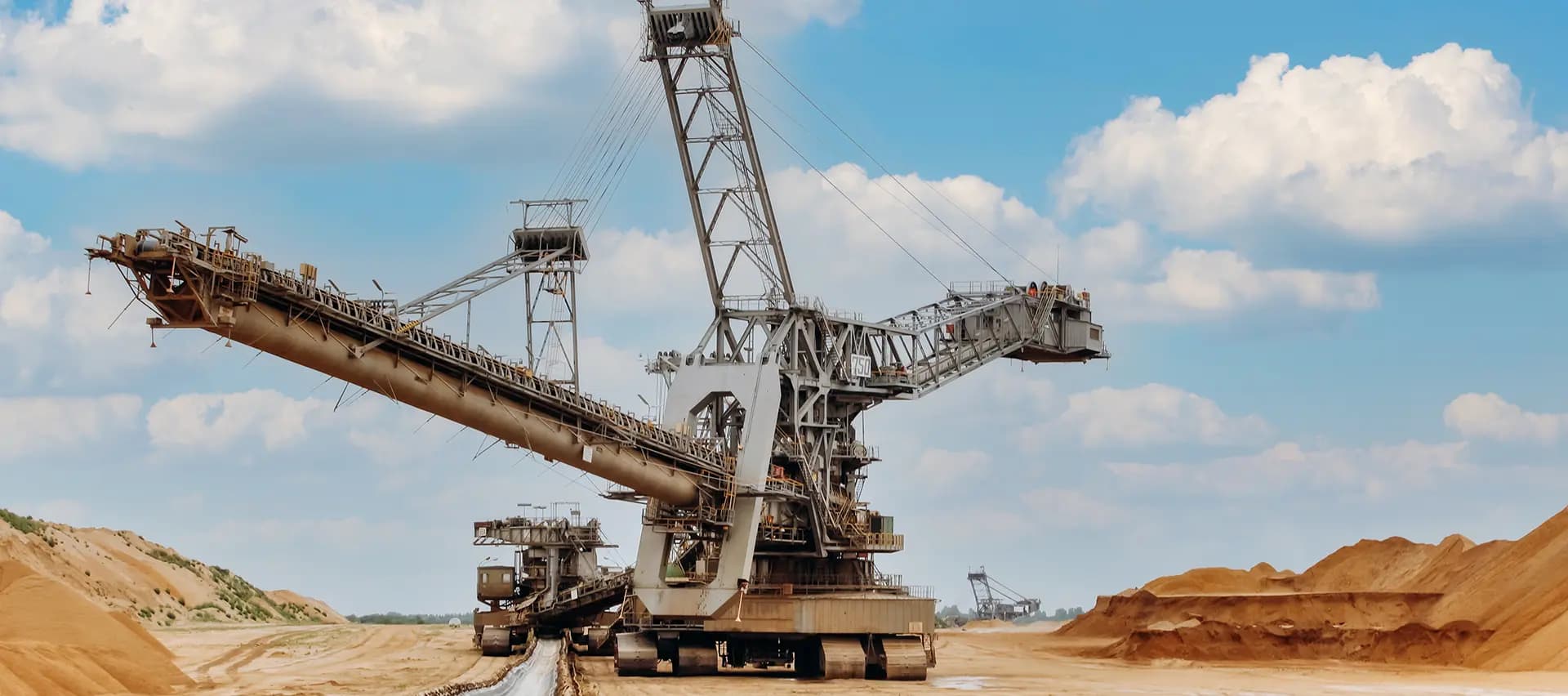 A bucket excavator sitting on land at a mining site.