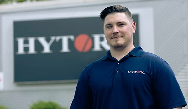 Two HYTORC employees in a warehouse setting.