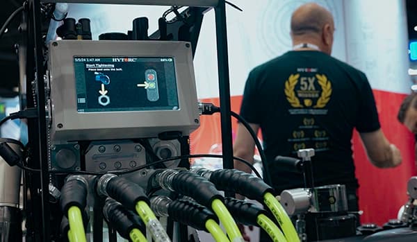 The LIGHTNING PUMP Smart shown at a trade show with a HYTORC technician in the background.