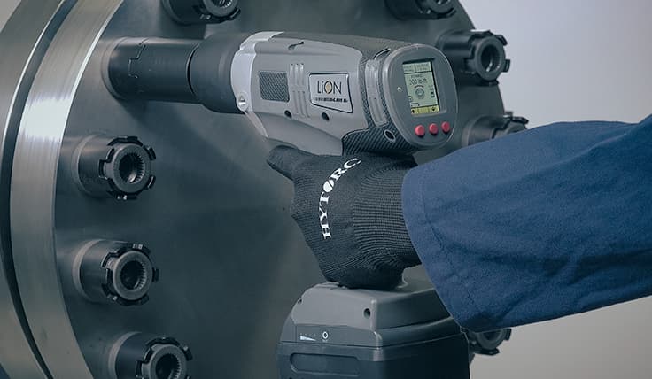 The LION GUN Electric Torque Tool with the HYTORC Nut Driver, shown overtop a HYTORC Nut showcasing that there is no need for a reaction arm