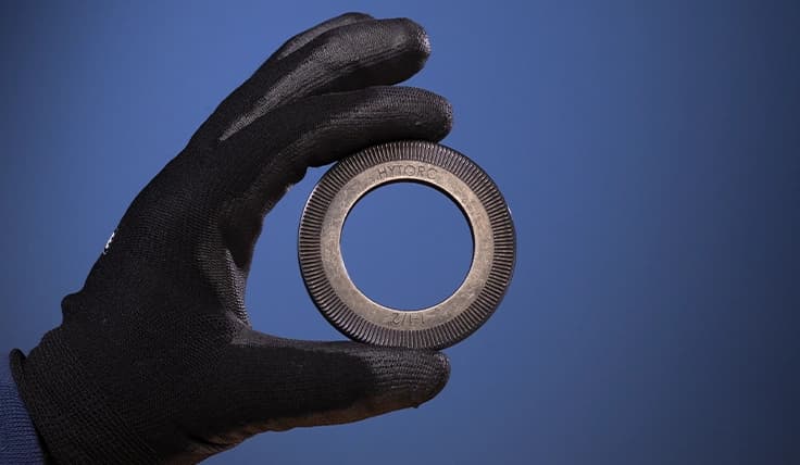 A gloved hand holding a TRUE-LOCK Washer