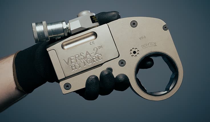 A side view of the VERSA Low Clearance Hydraulic Torque Wrench focused on the connection of the two components - the powerhead and the link.