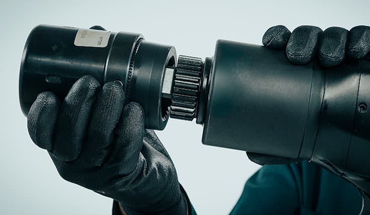 A gloved hand attaches the HYTORC Washer Driver to the jGun DIGITAL Single Speed Pneumatic Torque Tool.