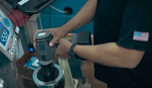 A HYTORC technician calibrating a LION Gun