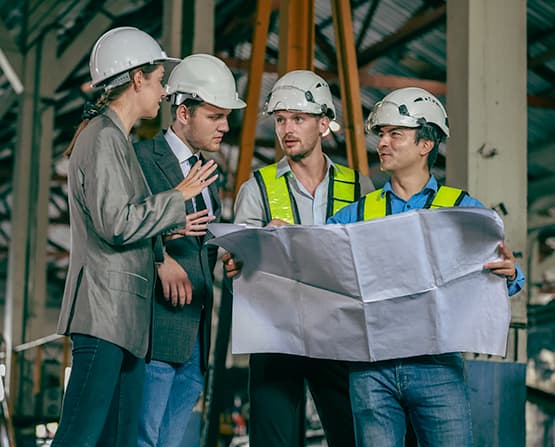 A team of engineers reviewing a plan for a custom fixture