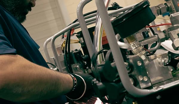 A technician interfacing with a hydraulic pump