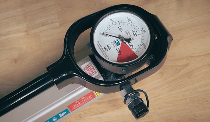 A close-up view of the Hand Tensioning Pump analog gauge