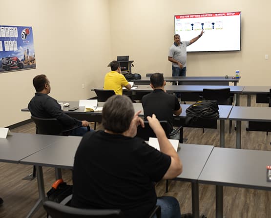 A classroom setting with a trainer and trainees